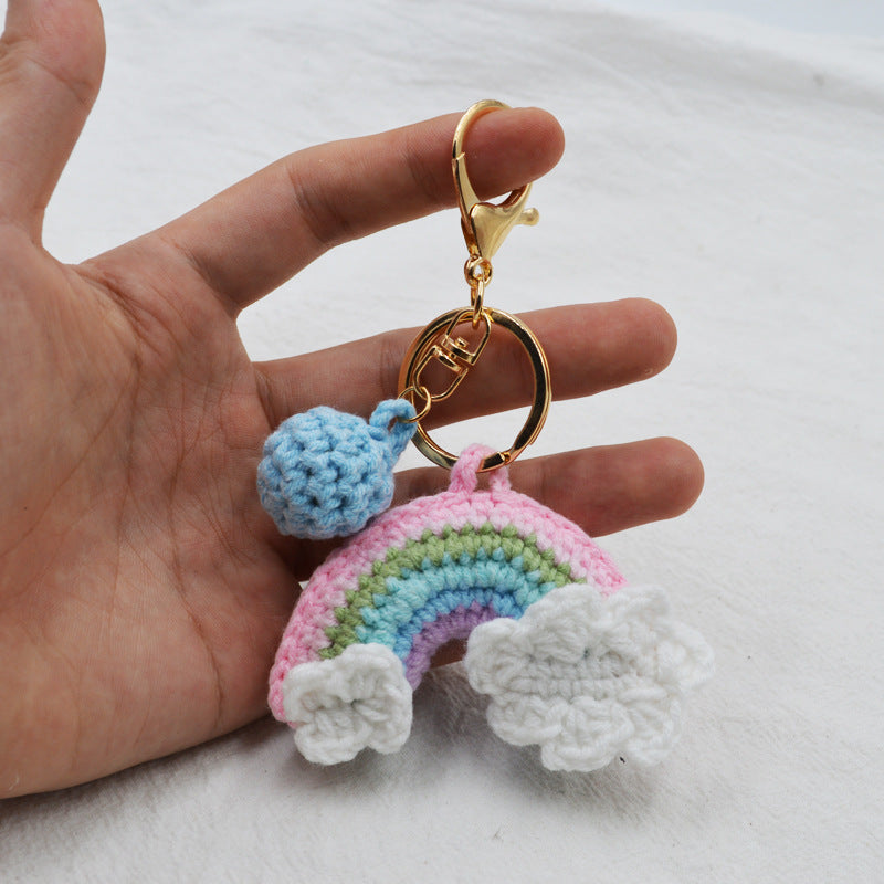 Handmade rainbow crochet key pendant attached to a backpack zip as a bag decoration — lightweight, portable keychain and thoughtful small gift