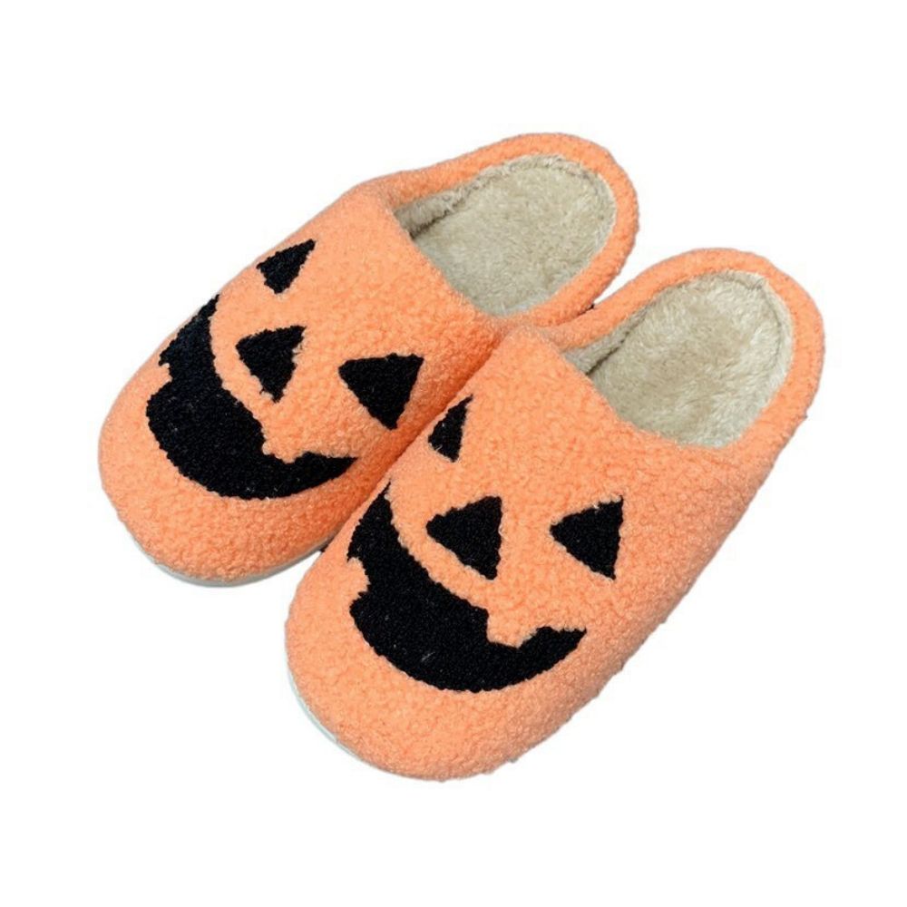Side view of yellow pumpkin foam slippers showing pumpkin motif and cushioned sole — cosy indoor Halloween slippers for men and women