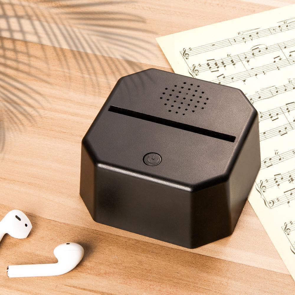 Angled view of the personalised Spotify Code LED lamp and Bluetooth speaker base, highlighting the clear acrylic panel, custom artwork and USB power interface