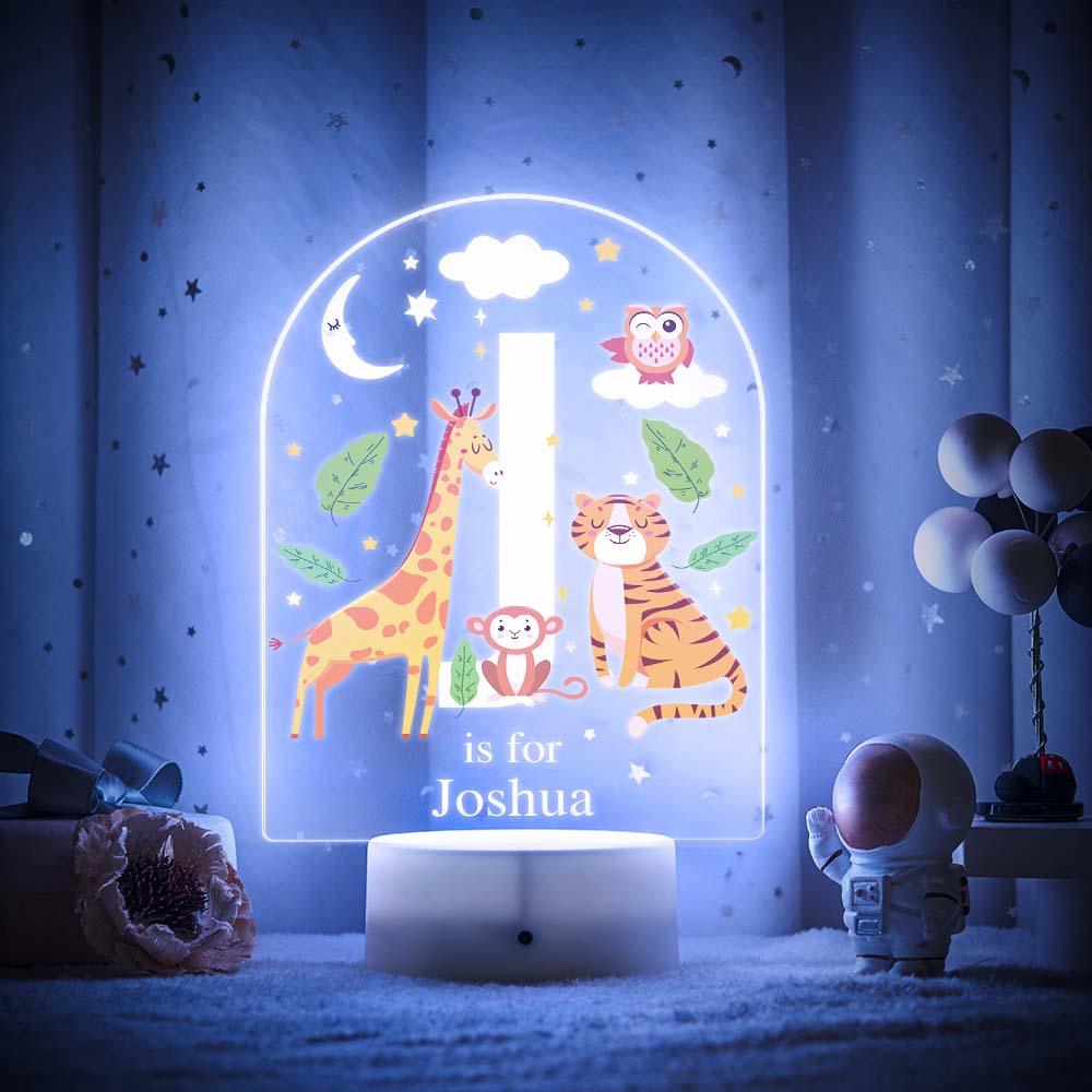 Engraved acrylic slide showing animal alphabet 'I' design with custom name example — personalised nursery lamp