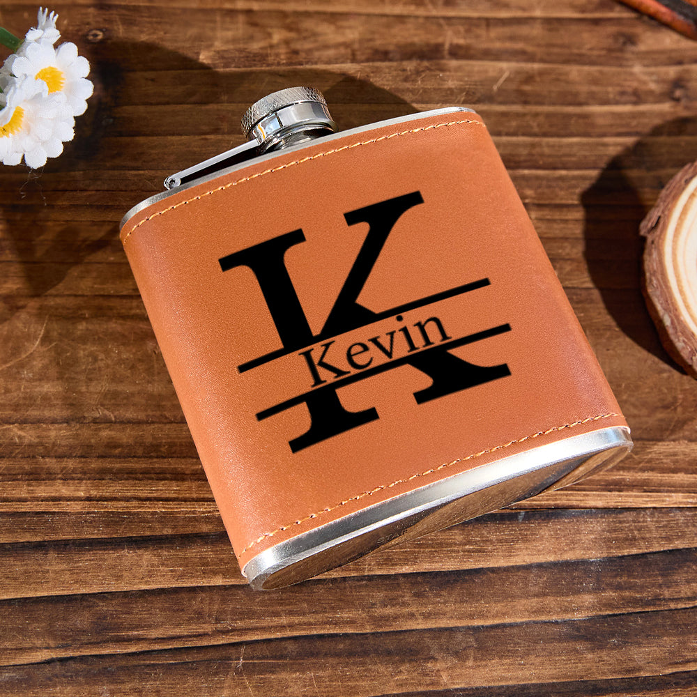 Compact 6oz personalised leather whisky flask held in hand to illustrate size (10.6 x 9.2 cm), stainless steel 304 core — ideal pocket flask and gifts for him
