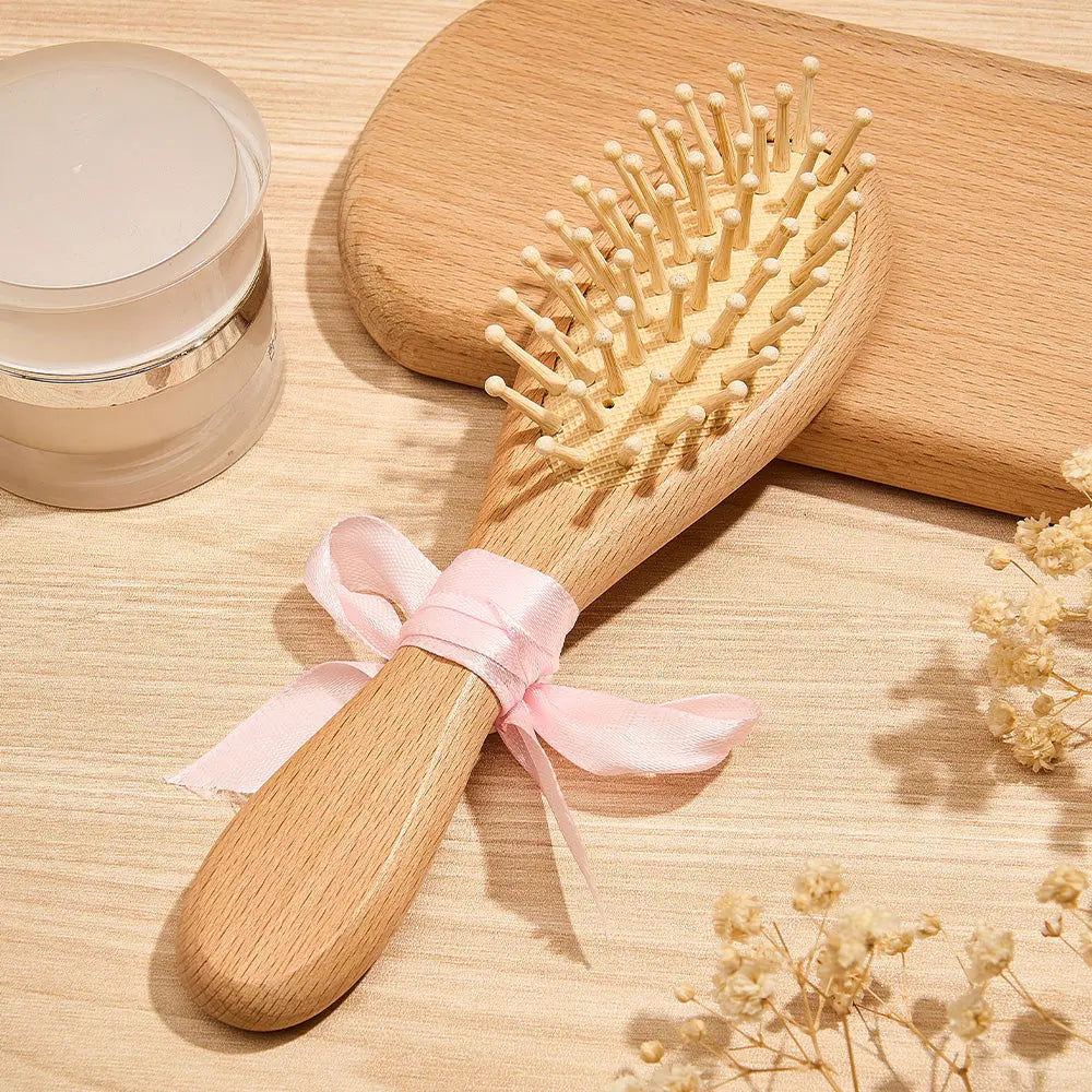 Side profile of baby hairbrush showing ultra-soft bristles and smooth handle — non-tugging care in this newborn grooming set