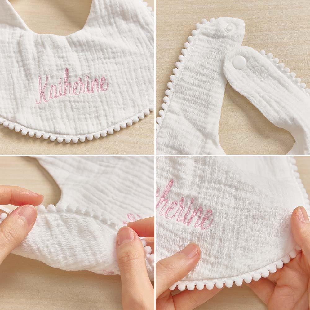 Close-up of embroidered name and neat stitching on a personalised cotton baby bib — ideal baby shower gift