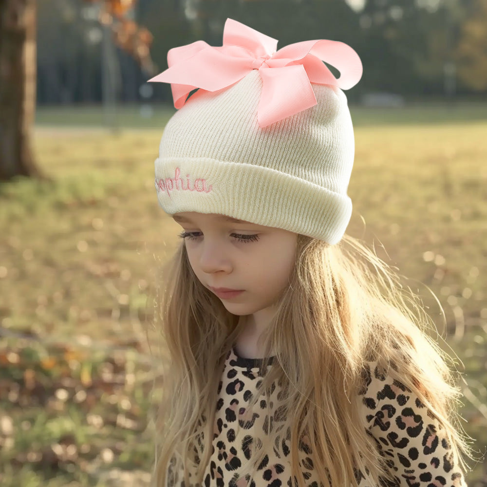Personalised knitted baby hat with bow — custom name embroidery on soft polyester yarn, suitable for newborns and toddlers (48–54 cm)