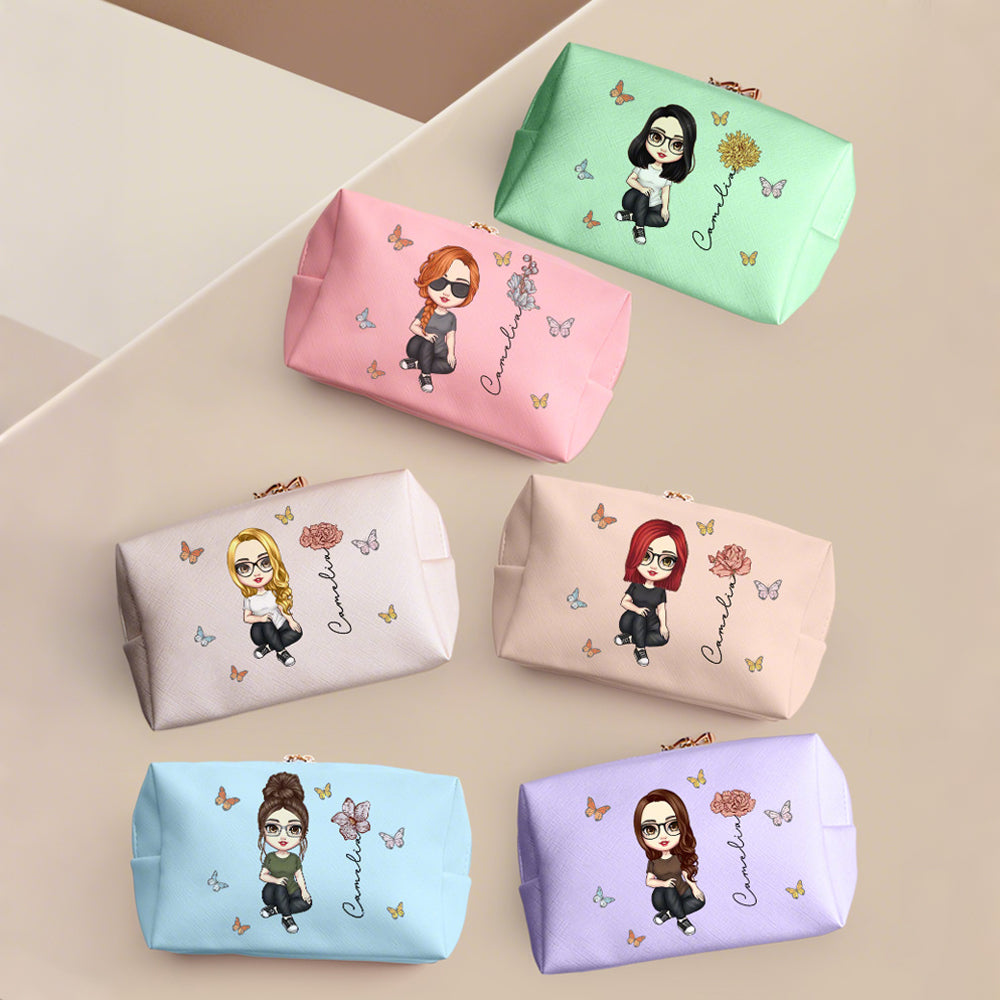 Collection of personalised cosmetic bags showing birth flower designs and cartoon character artwork on premium PU leather