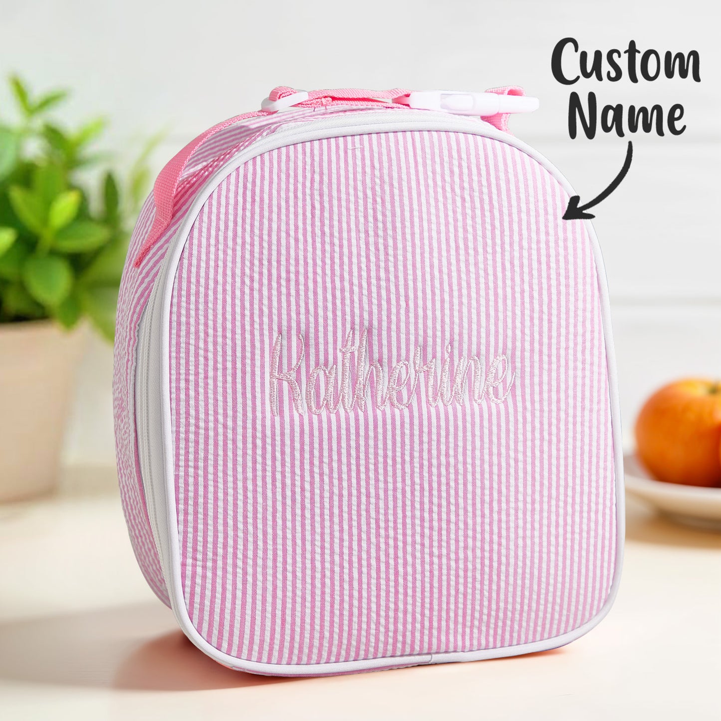 Lifestyle shot of a child carrying a personalised seersucker lunch bag with embroidered name — perfect birthday gift for boys and girls