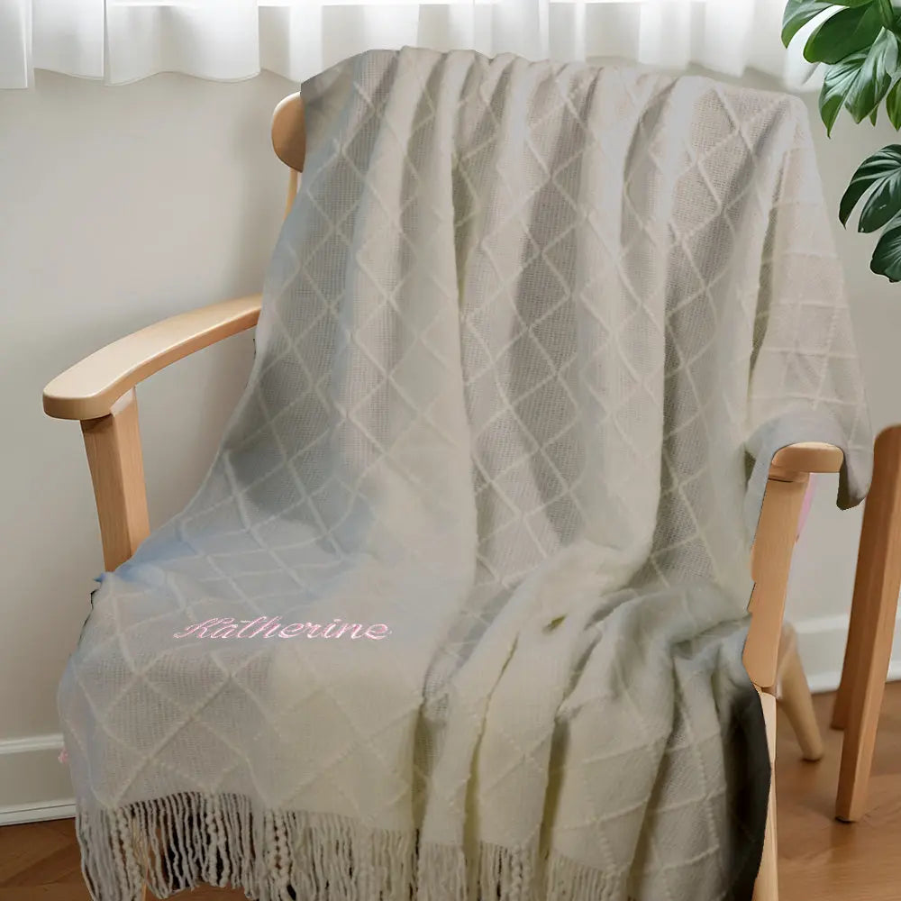 Close-up of tassel strands and cotton weave in the personalised blanket.