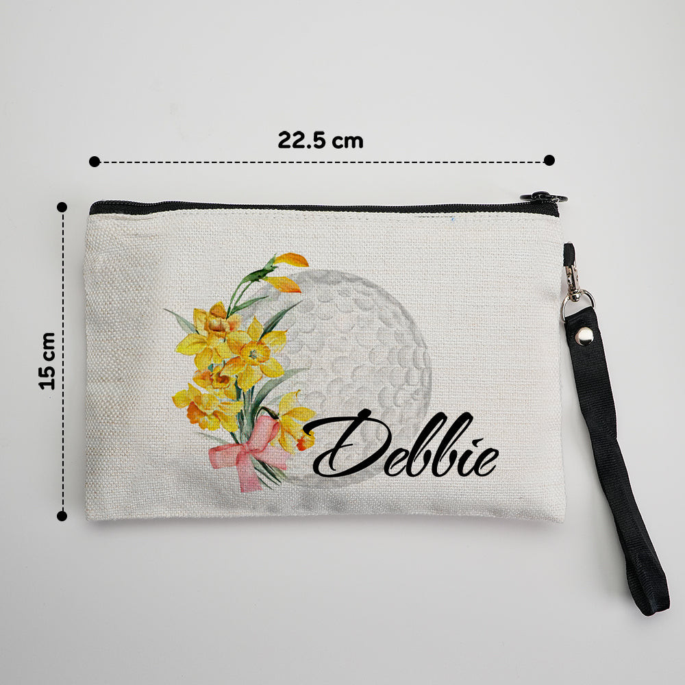 Close-up of durable canvas fabric and secure zip, highlighting the printed custom name, birth flower illustration and subtle golf ball motif on the personalised makeup pouch