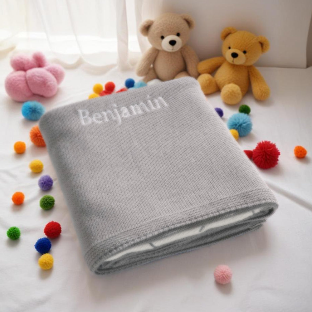 Machine-washable baby blanket on gentle cycle with grey elephant design.