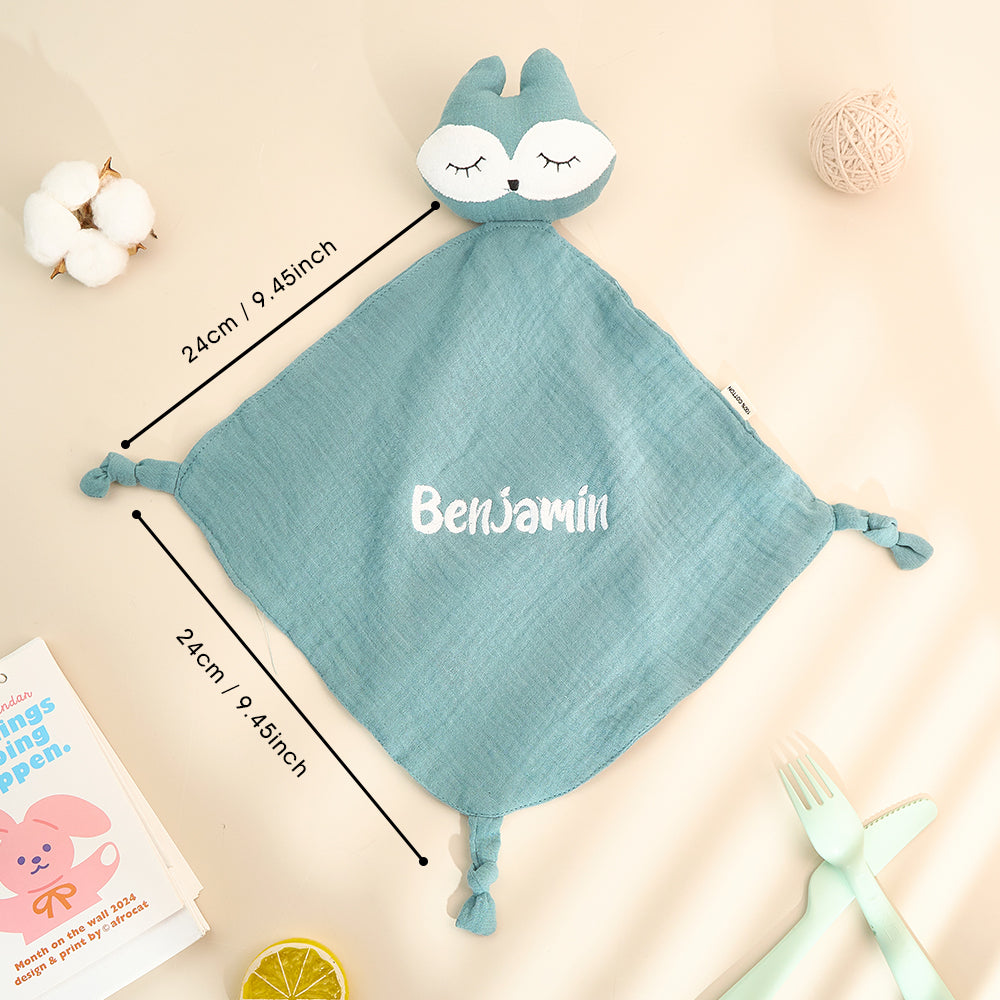 Baby holding a personalised embroidered comfort towel — soft cotton soother with name stitching, a treasured newborn keepsake