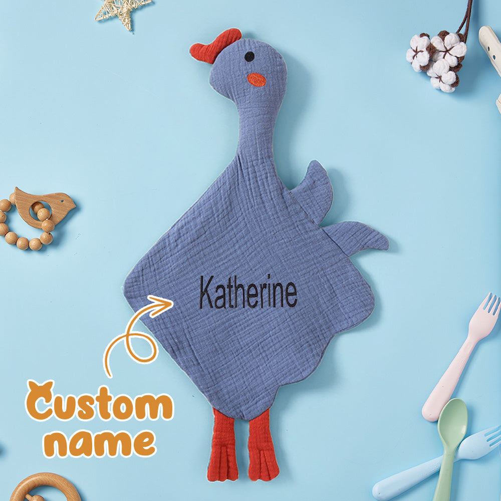 Baby holding personalised swan comforter with embroidered name — comforting personalised baby soothing towel for naps and bedtime