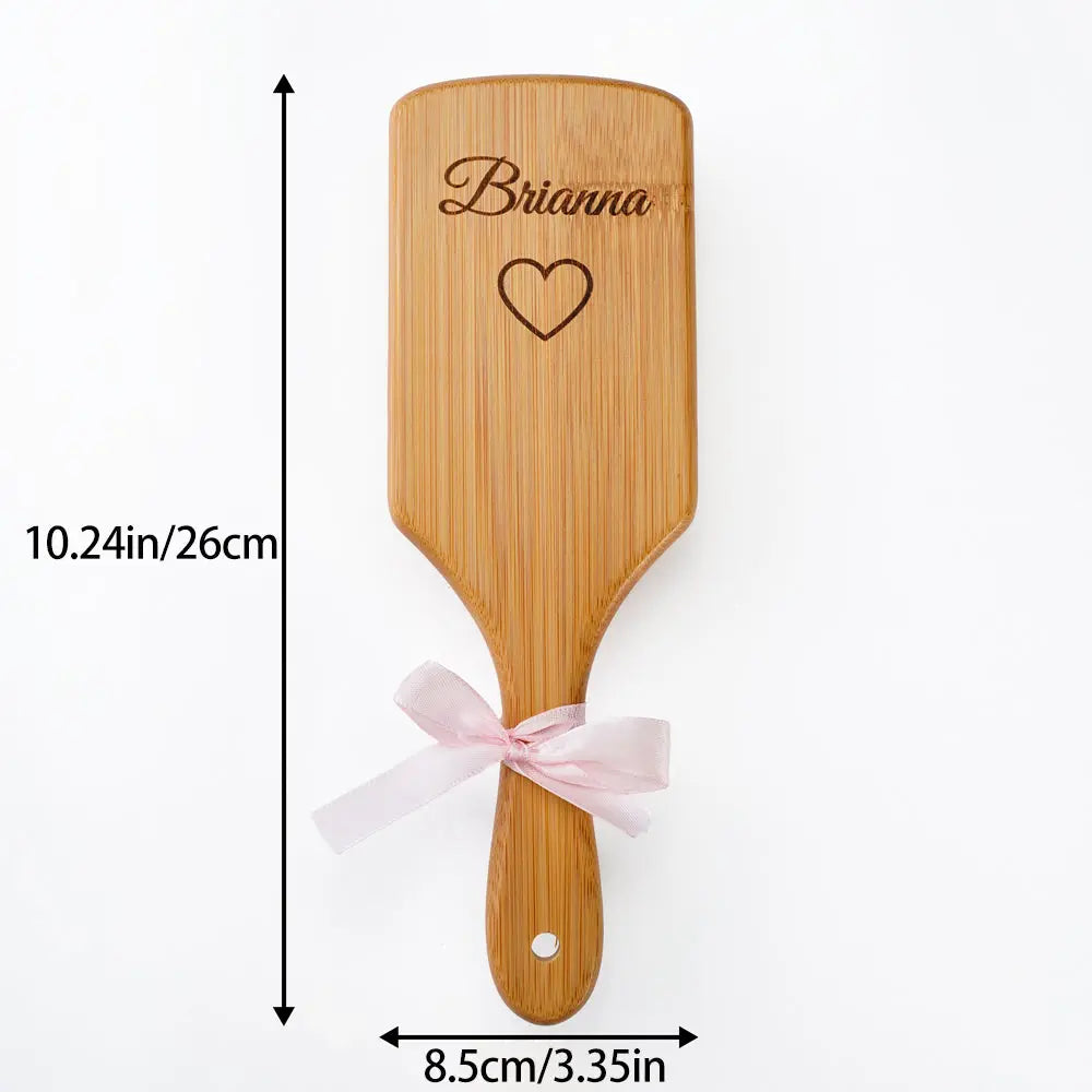 Close-up of laser engraved name on bamboo hairbrush – bespoke custom engraving for wedding gifts and thank-you presents