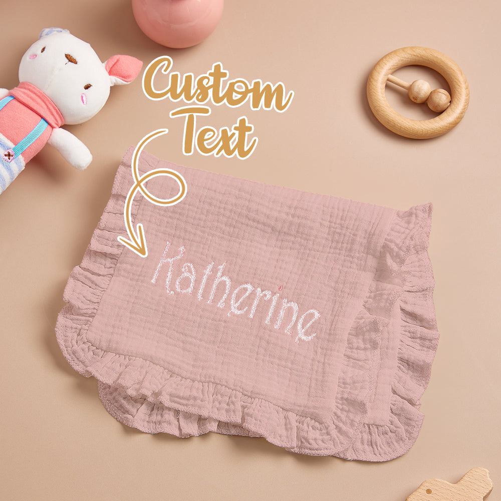 Embroidered name visible against white muslin backdrop.