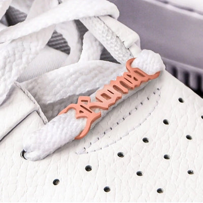 Gold personalised name metal shoelace charm threaded on trainer laces, custom shoe buckle detail