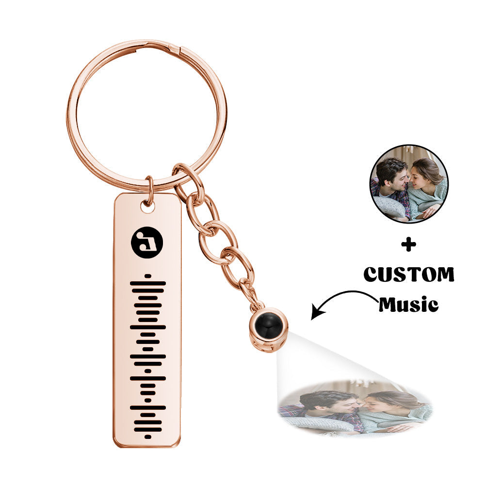 Close-up engraved metal plaque of personalised projection music keychain showing custom name and artist – custom song keyring