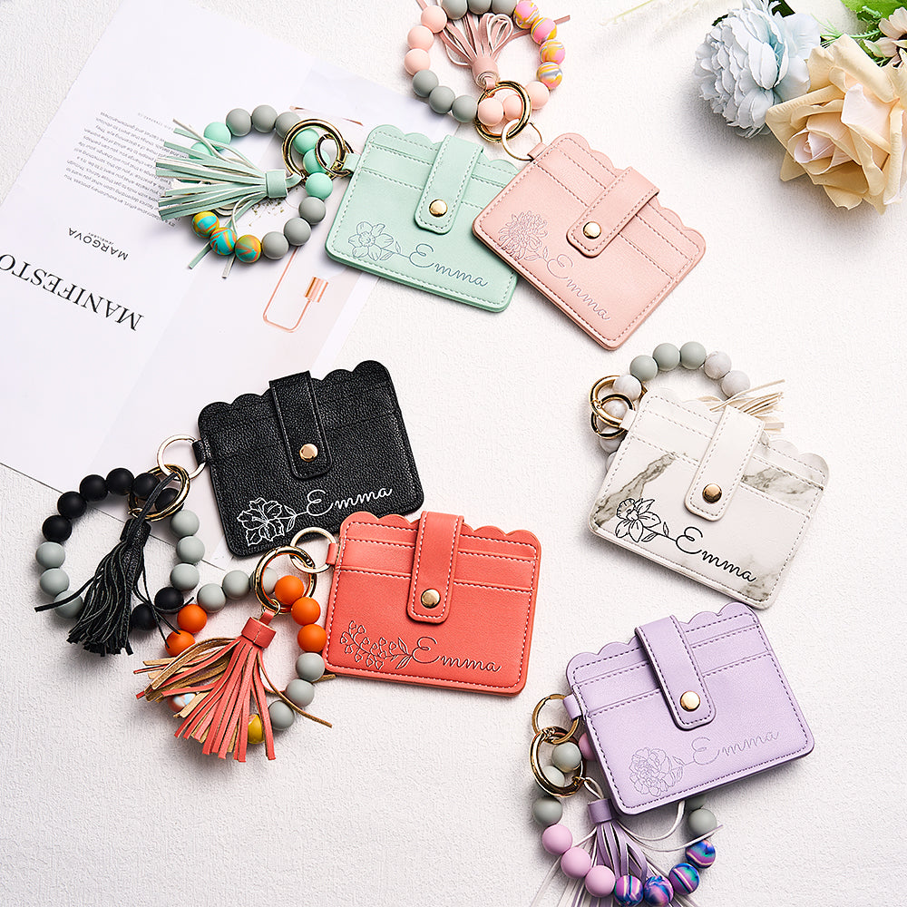Close-up of detachable beaded bracelet and clasp detail on personalised birth flower card wallet, wearable wrist strap