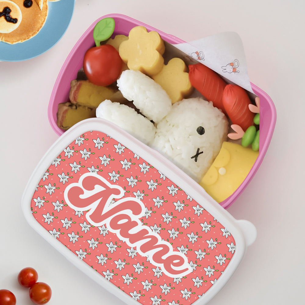Close-up of customised name on cute floral personalised lunch box – personalised name gift to reduce loss at nursery or school