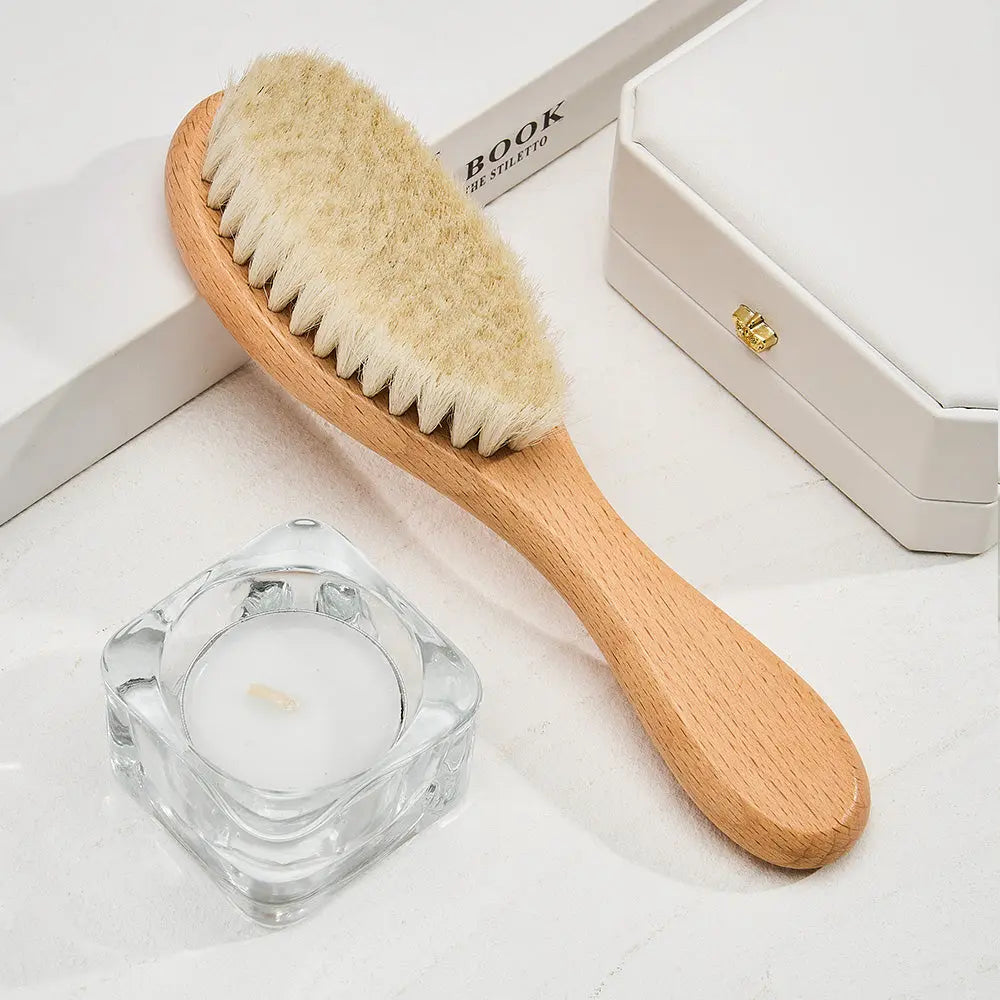 Close-up of ultra-soft bristles on an engraved baby brush — soft detangling for delicate newborn hair in this wooden baby comb set