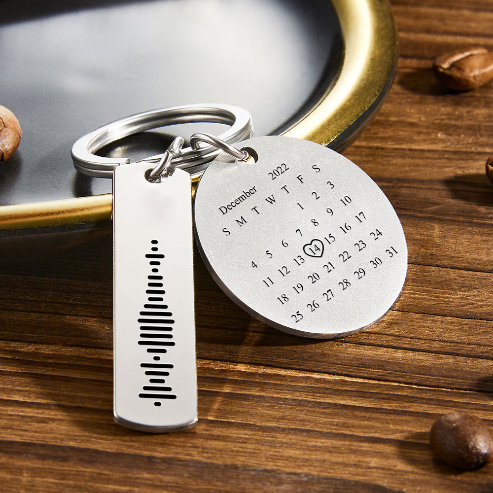 Close-up of laser double-sided engraving on personalised music code keyring, highlighting crisp photo, text and calendar detail on stainless steel