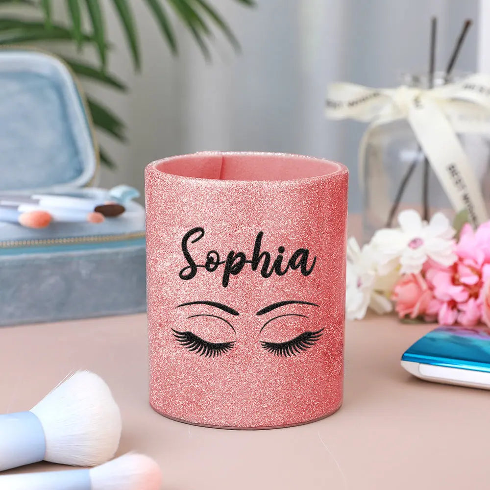 Personalised glitter leather brush cup holding a selection of makeup brushes, illustrating organised vanity storage and easy-to-use design