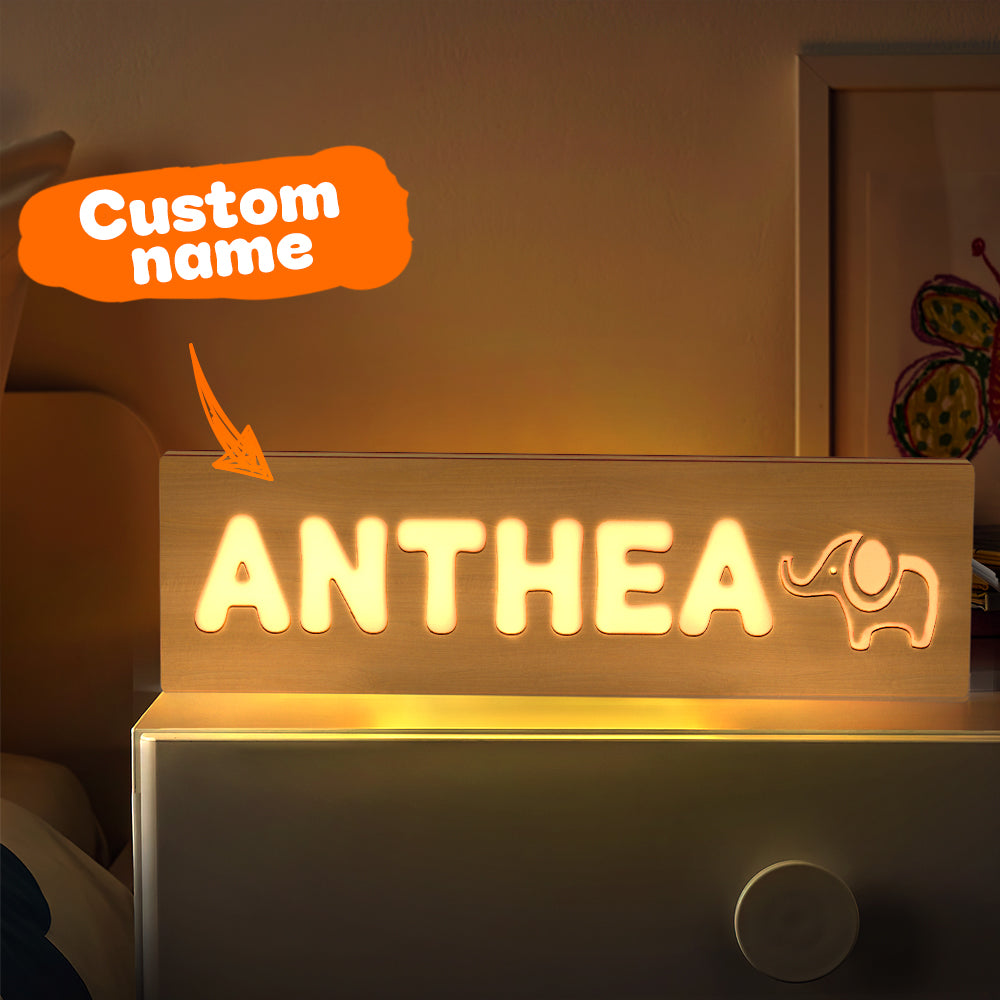 Detail of the warm LED diffuser behind engraved letters on a personalised wooden night light — soft light for toddler bedrooms