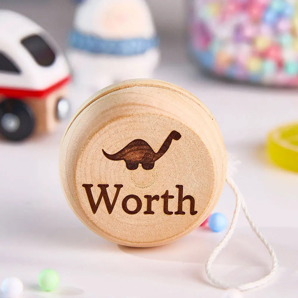 Collection of personalised wooden yo-yos each with different engraved names — ideal name gifts for kids, teens and classmates