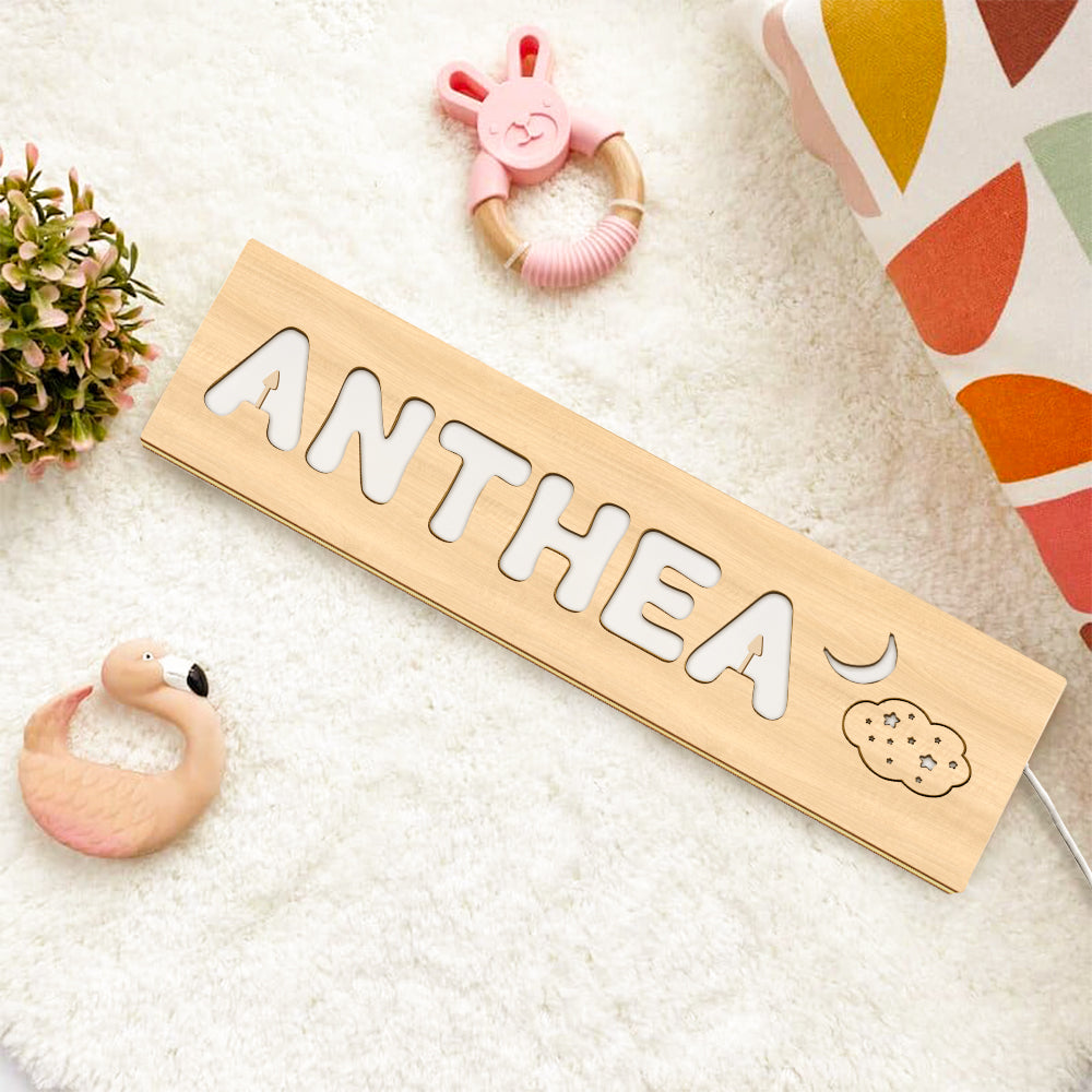 Close-up of the lamp base showing stable wooden stand and cable entry on a personalised wooden night light — safe nursery lamp