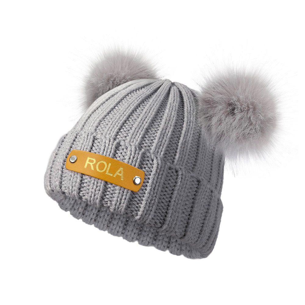 Personalised baby beanie presented as a keepsake gift with custom name leather patch – ideal for first birthdays and Christmas