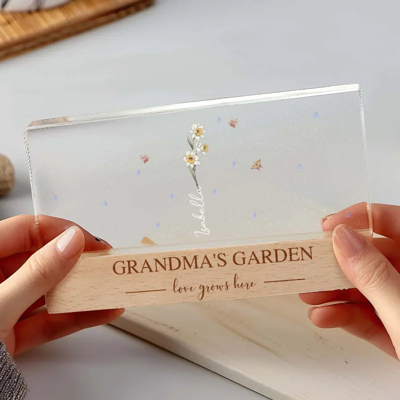 Close-up of engraved family names and birth flowers on LED acrylic keepsake for Grandma