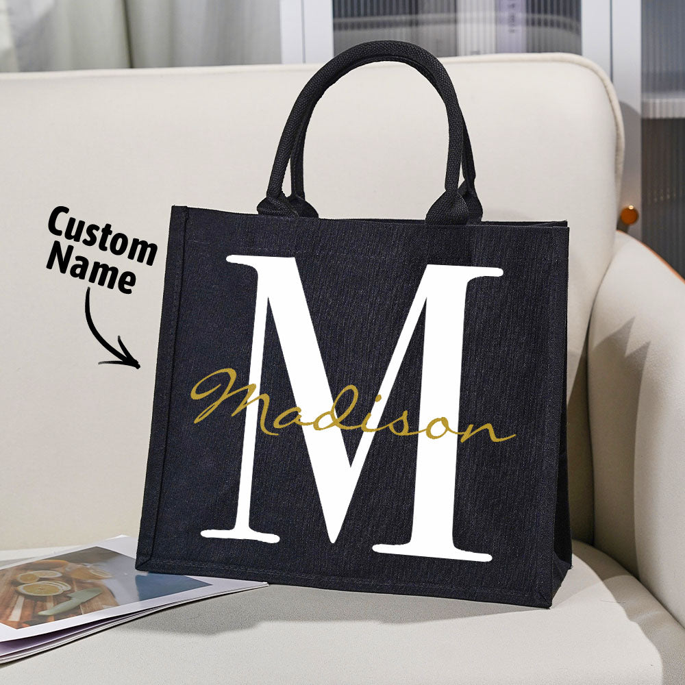 Detail shot of sturdy handles and reinforced stitching on personalised black canvas name and initial tote, highlighting durable construction