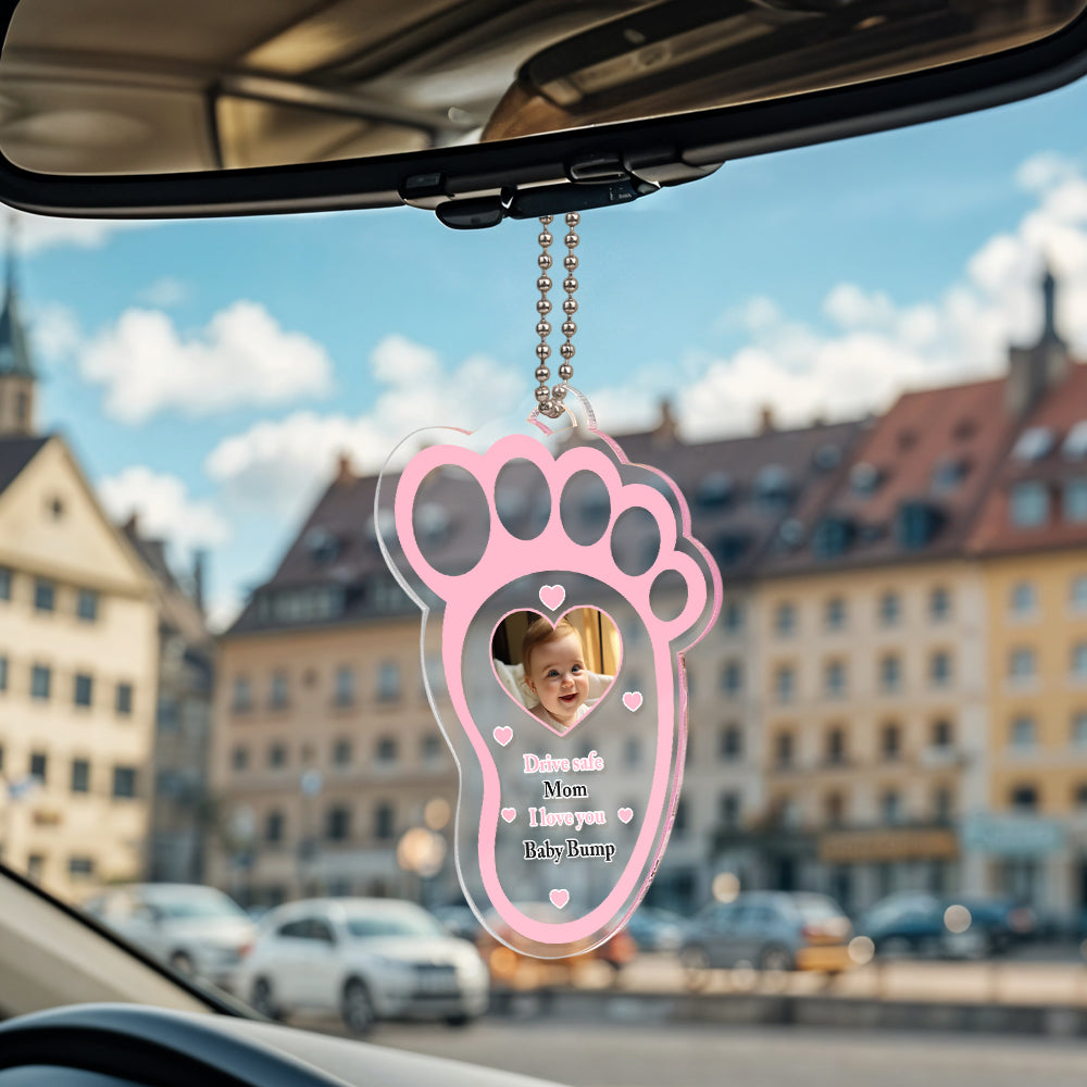 Personalised drive safe baby footprint car mirror hanger in clear acrylic, a custom photo gift for dads featuring a baby footprint motif.