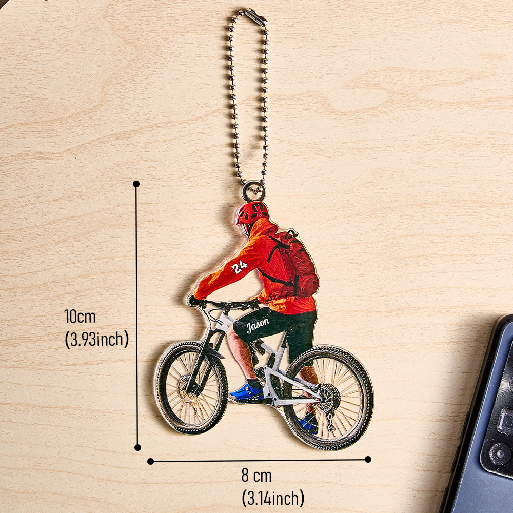 Product layout showing personalised mountain biking ornament with size reference and optional name engraving — acrylic cyclist gift