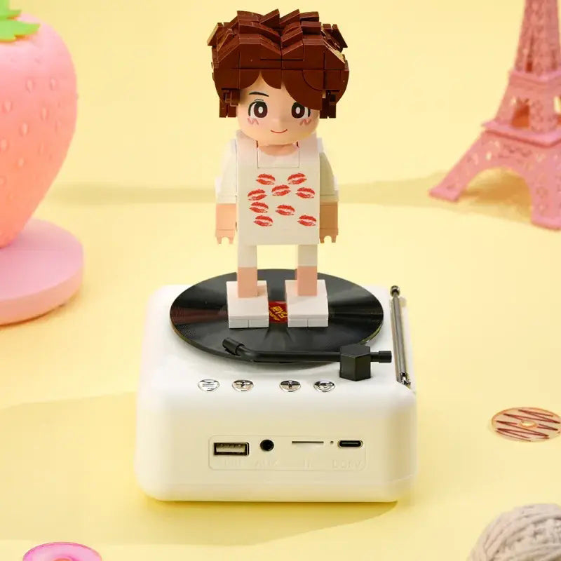 Lifestyle shot of personalised brick figure speaker displayed on a shelf as an anniversary or birthday keepsake — custom brick figure speaker