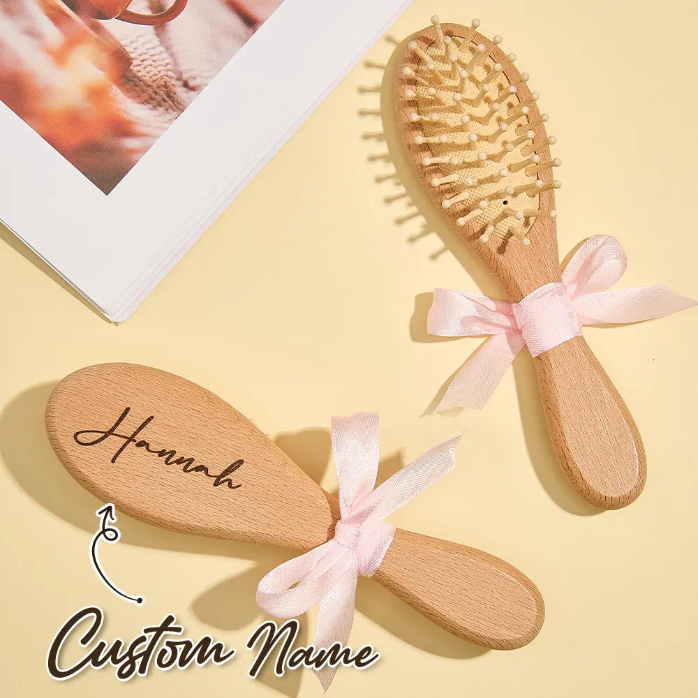 Lightweight ergonomic wooden brush shown in hand to illustrate size (17.8cm x 4.8cm) — practical newborn grooming set for parents