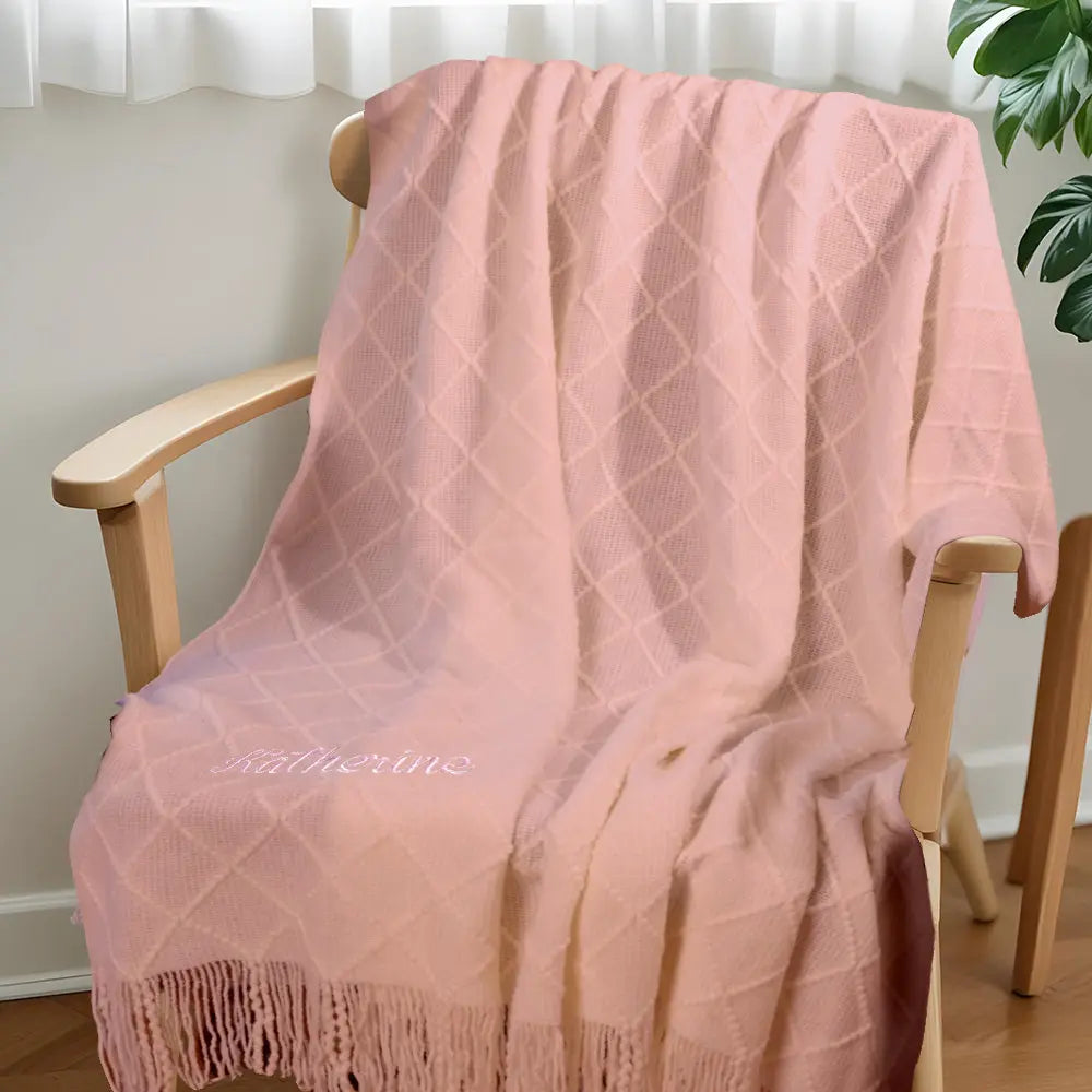 Close-up of tassel strands and cotton weave in the personalised blanket.
