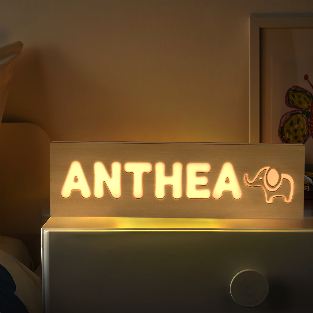 Top-down view of a personalised wooden night light showing engraved wording layout and clean laser edges — engraved name lamp precision