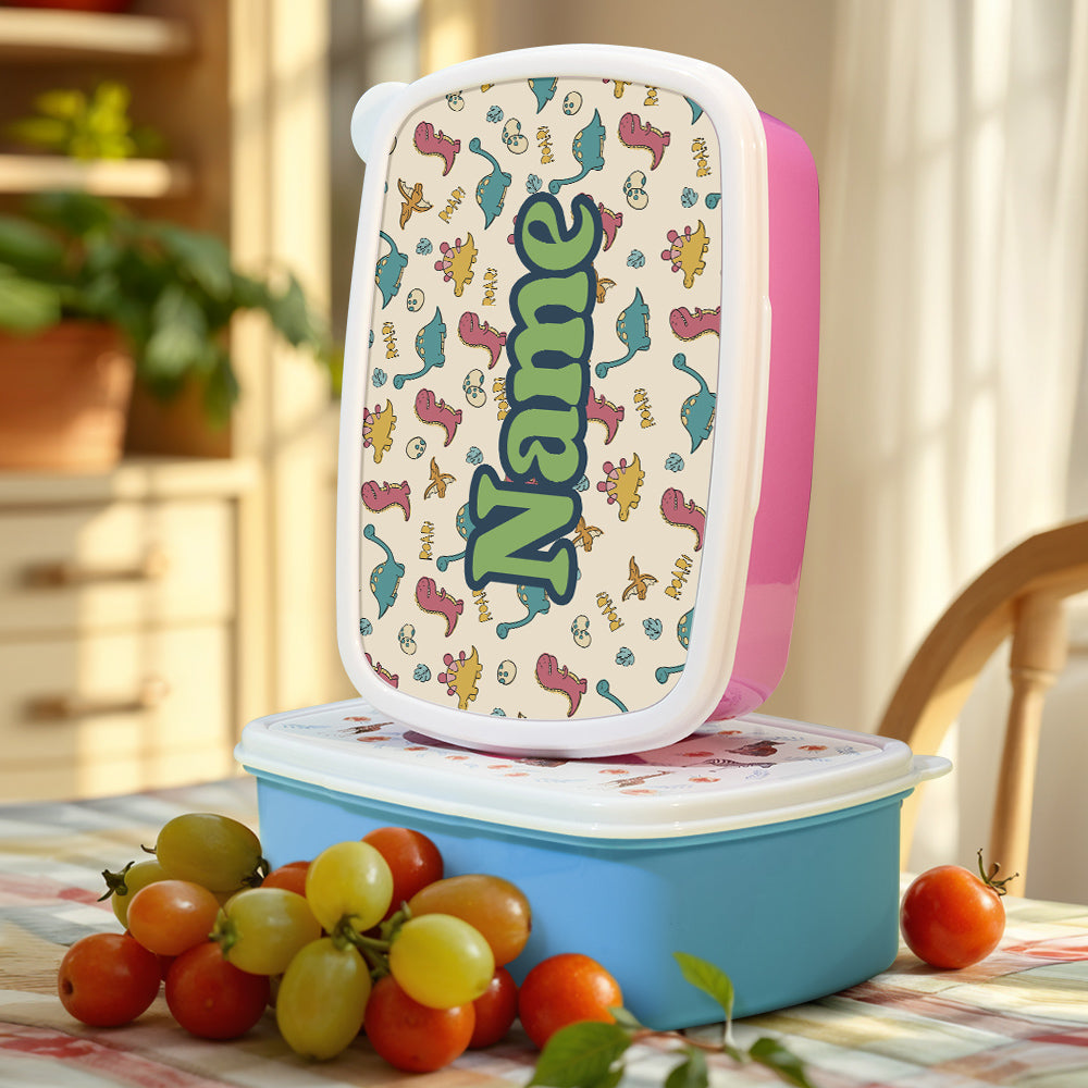 Lightweight personalised dinosaur lunch box held in a child’s hand – easy-clean snack box for school and picnics