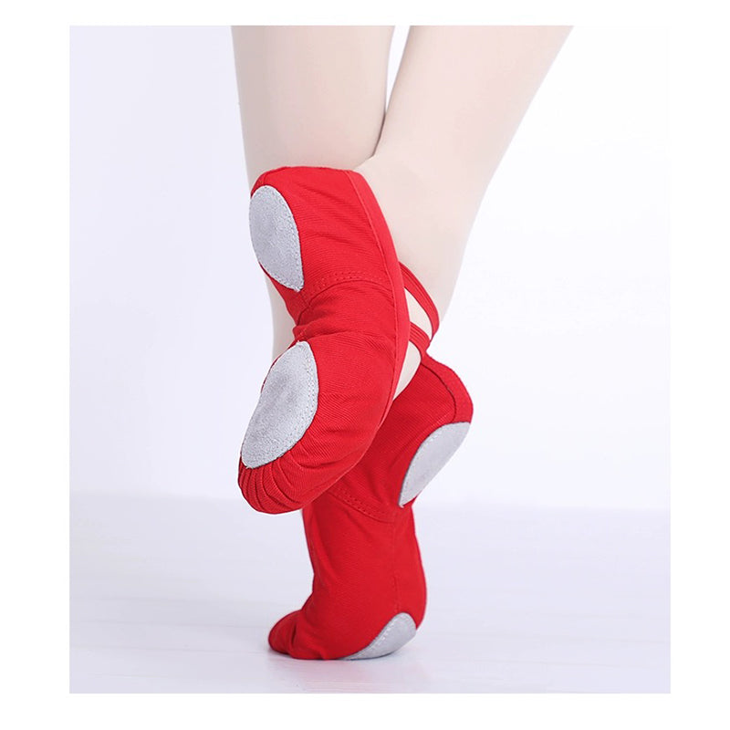 Four colour options pink tan black and red canvas split sole ballet shoes displayed together versatile dance slippers for children and adults