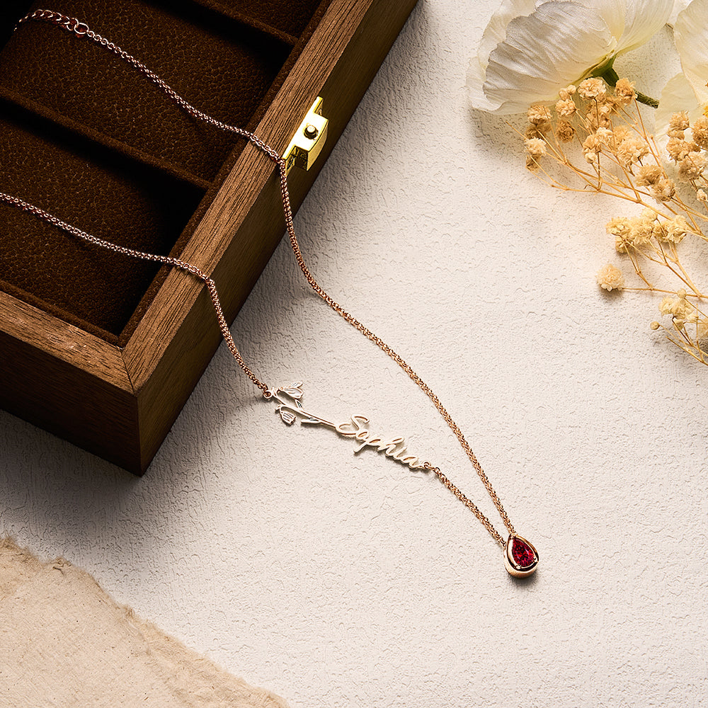 Collection of personalised name necklaces highlighting a variety of birth flowers and birthstones – meaningful personalised gifts