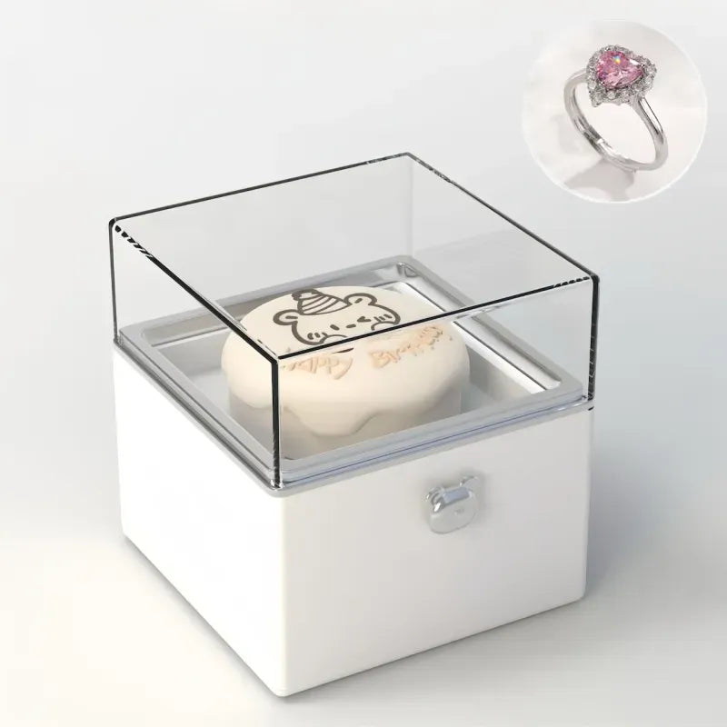 Bear Cake Ring Box displaying an engagement ring on the rising mechanism — ideal for Valentine's Day or promise ring moments