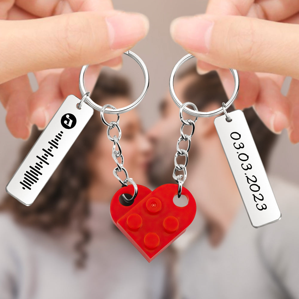 Close‑up of a personalised heart brick keyring showing detailed music code engraving and custom names – personalised couples keepsake