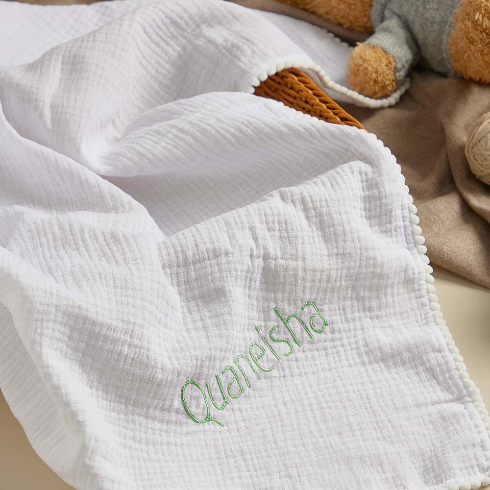 Newborn baby swaddle blanket made from lightweight cotton muslin.