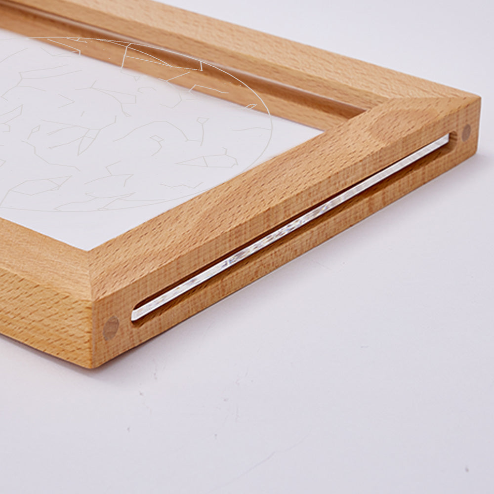 Daytime view of a personalised engraved star map as stylish desk decor — clear acrylic plaque in wood frame ready for free online customisation and dropshipping