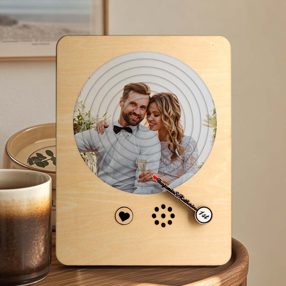 Close-up of engraved wooden music player displaying personalised names and date — bespoke engraved wooden record player