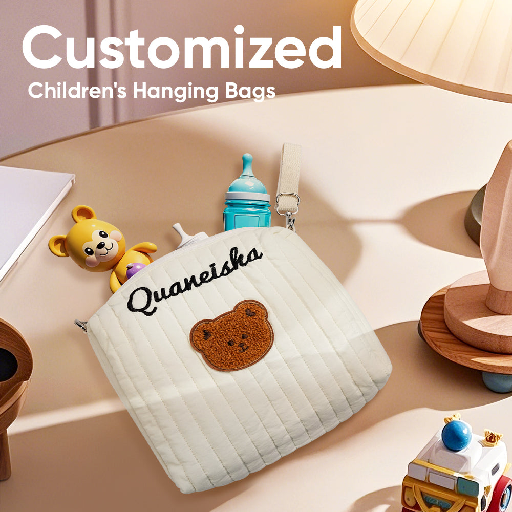 Front view of the Personalised Stroller Hanging Bag on a pushchair showing embroidered name.