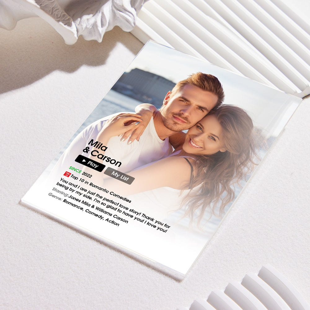 Angled view of a personalised acrylic movie poster plaque showing a custom photo, year and short quote — bespoke custom photo & text keepsake made from recyclable acrylic