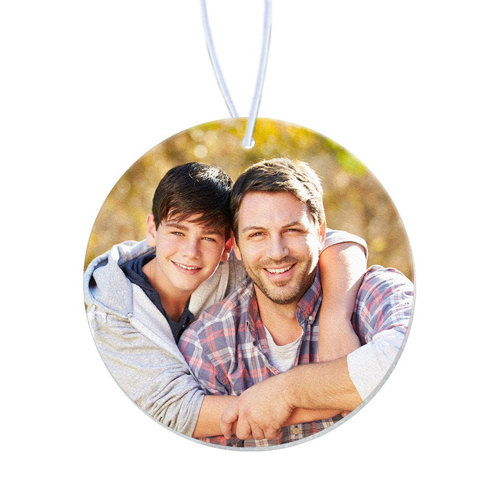 Product shot of a round car air freshener highlighting its compact hanging design and printed image on soft felt.