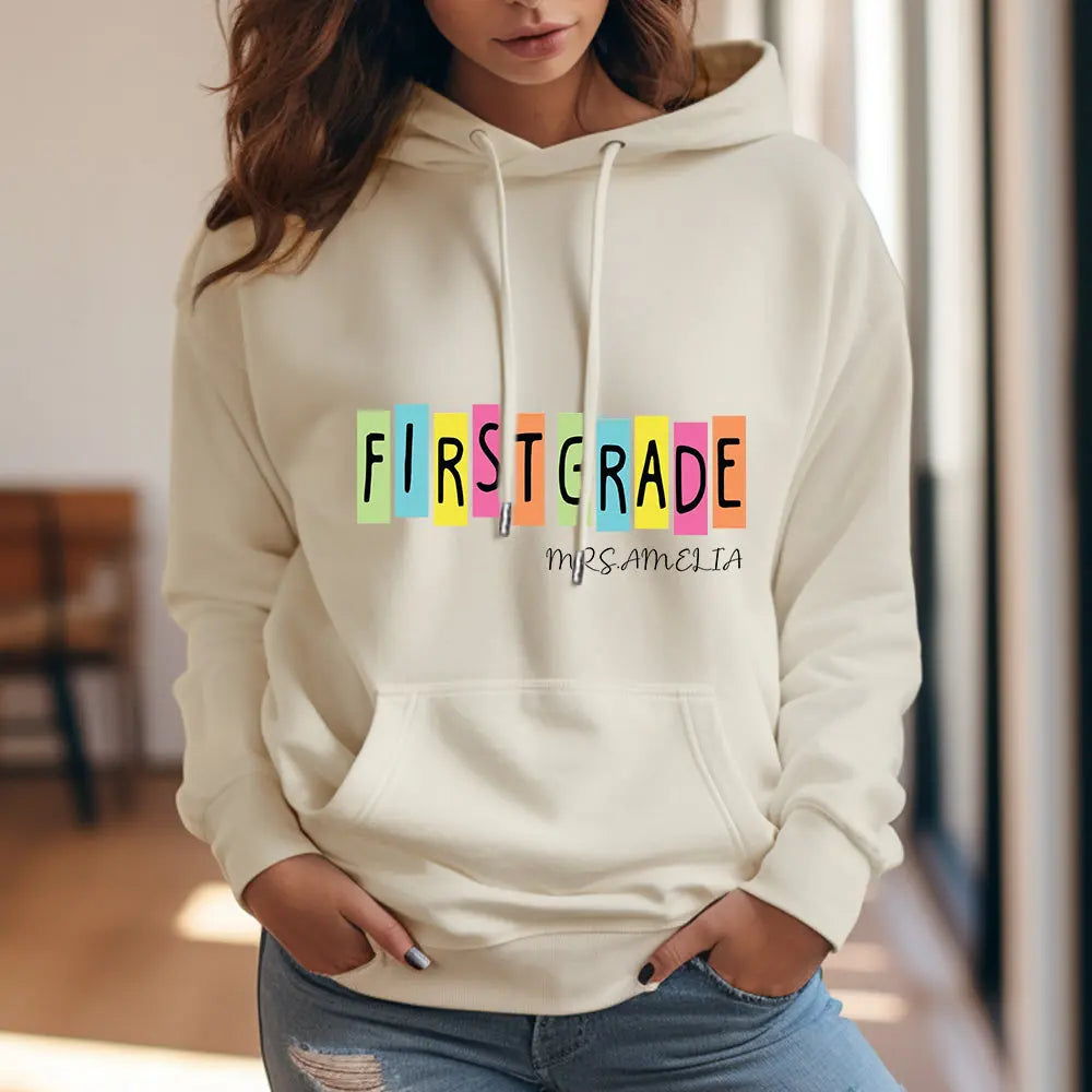 Detail of hood, stitching and drawcords on personalised first grade hooded sweatshirt — durable polyester construction for teachers.