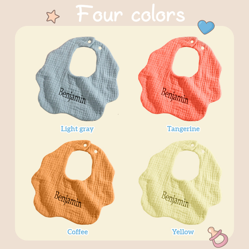 Care instructions and material tag on a personalised cotton bib — machine-washable embroidered name bib
