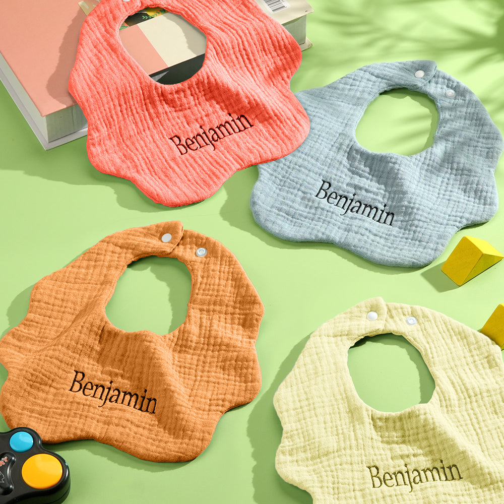 Infant wearing a personalised embroidered name bib at mealtime — practical cotton bib for newborns